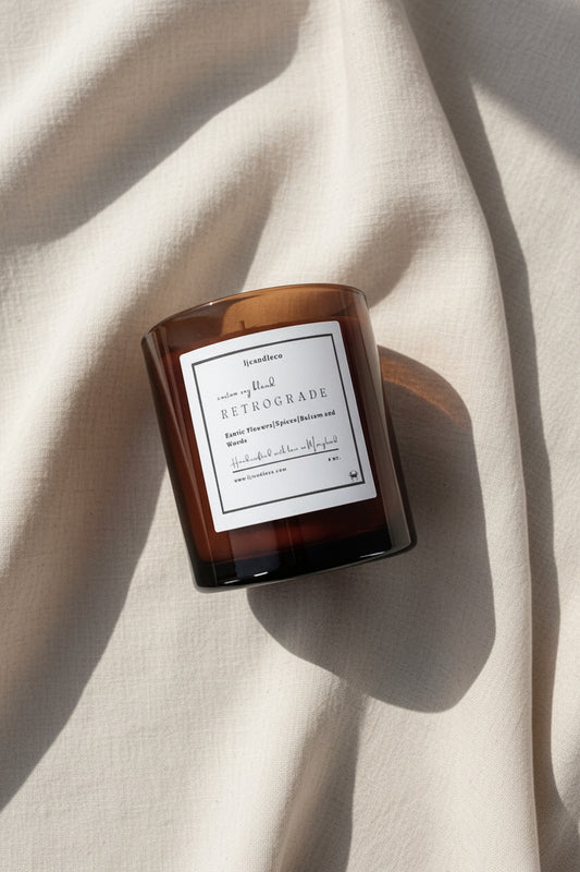 LJ Candle Co Retrograde scented candle in a glass jar with a wooden lid, displaying a warm, cozy ambiance.