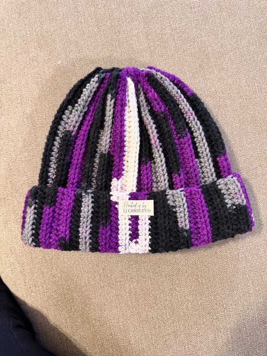 Flocked beanie hat with purple, black, gray, and white stripes, folded cuff, and LJ Candle Co label, on beige background.